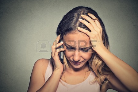 45715075-portrait-unhappy-young-woman-talking-on-mobile-phone-looking-down-human-face-expression-emotion-bad